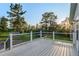 Spacious back deck overlooking a beautiful lawn with mature trees and a play area, perfect for outdoor entertaining at 652 Verdos Dr, Elizabeth, CO 80107