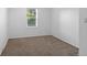 A cozy bedroom offers natural light through the window and neutral-toned carpeting at 652 Verdos Dr, Elizabeth, CO 80107