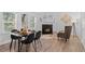 Stylish dining area with fireplace, modern table, and comfortable seating, perfect for intimate gatherings at 652 Verdos Dr, Elizabeth, CO 80107