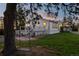 Exterior shot of the home with swing under tree in yard and cozy deck at dusk at 652 Verdos Dr, Elizabeth, CO 80107