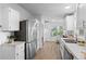 Bright kitchen featuring stainless steel appliances, ample counter space, white cabinets, and stylish fixtures at 652 Verdos Dr, Elizabeth, CO 80107