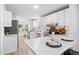 Well-lit kitchen with stainless steel appliances, a breakfast bar, modern countertops and white cabinetry at 652 Verdos Dr, Elizabeth, CO 80107