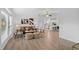 Bright open living room with neutral tones, wood floors, and comfortable seating, flowing into a modern white kitchen at 652 Verdos Dr, Elizabeth, CO 80107