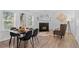 Cozy living room with fireplace and modern decor, plus dining area with wood flooring and abundant natural light at 652 Verdos Dr, Elizabeth, CO 80107