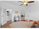 Light filled main bedroom features modern ceiling fan, wood look floors, neutral decor and closet access at 652 Verdos Dr, Elizabeth, CO 80107