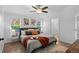 Bright main bedroom with natural light, wood-look floors, neutral decor and an en-suite bathroom at 652 Verdos Dr, Elizabeth, CO 80107