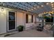 Inviting covered patio with string lights, comfortable seating, and stylish decor for outdoor relaxation at 652 Verdos Dr, Elizabeth, CO 80107