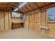Inside of shed featuring built-in shelving and a workbench, offering a functional space for hobbies and storage at 652 Verdos Dr, Elizabeth, CO 80107