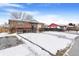 Snow-covered yard with a brick home, and neighboring houses visible at 1381 Mariposa Dr, Denver, CO 80221