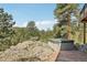 Hot tub overlooking a rock outcrop with trees and blue skies in the background at 30206 Telluride Ln, Evergreen, CO 80439