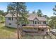 Home features a large back deck, stone patio, and lovely wooded views at 30206 Telluride Ln, Evergreen, CO 80439