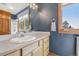 Stylish bathroom featuring a modern vanity, window with natural light, and white-tiled shower at 30206 Telluride Ln, Evergreen, CO 80439