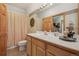 Bathroom with a shower and tub combo, and a sink with wood cabinets at 30206 Telluride Ln, Evergreen, CO 80439