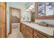 Well-lit bathroom with a bathtub, double sinks, and ample counter space, with neutral tones at 30206 Telluride Ln, Evergreen, CO 80439