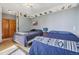 Shared bedroom with two beds, wooden floors, and neutral wall colors, horse themed décor at 30206 Telluride Ln, Evergreen, CO 80439
