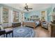 Bright bedroom with hardwood floors, ceiling fan, comfortable king bed, and beautiful views at 30206 Telluride Ln, Evergreen, CO 80439