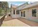 Back deck with a grill and many windows providing ample natural light into the home at 30206 Telluride Ln, Evergreen, CO 80439