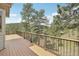 Spacious wood deck with metal railings and stunning views of the forest and mountains at 30206 Telluride Ln, Evergreen, CO 80439
