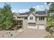 Exterior facade of a large, two-story home with a three car garage and solar panels at 30206 Telluride Ln, Evergreen, CO 80439