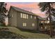 Charming home featuring a spacious deck overlooking the yard, set against a picturesque sky at 30206 Telluride Ln, Evergreen, CO 80439