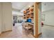 Dedicated office space with custom built-in bookshelves and a desk looking into the living room at 30206 Telluride Ln, Evergreen, CO 80439