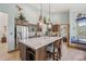 Bright kitchen boasts a large center island, stainless steel appliances, and wood cabinets at 30206 Telluride Ln, Evergreen, CO 80439