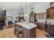 Spacious kitchen with an island, stainless steel appliances, wooden cabinets, and breakfast bar seating at 30206 Telluride Ln, Evergreen, CO 80439