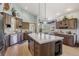 Bright kitchen features a large center island with seating, stainless steel appliances, and hardwood flooring at 30206 Telluride Ln, Evergreen, CO 80439