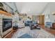 Inviting living room with a stone fireplace, large windows, and comfortable furnishings at 30206 Telluride Ln, Evergreen, CO 80439