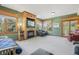 Spacious living room with a fireplace, built-in shelving, and multiple windows providing ample natural light at 30206 Telluride Ln, Evergreen, CO 80439