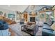 Spacious living room features a cozy fireplace, large windows, and comfortable furnishings at 30206 Telluride Ln, Evergreen, CO 80439