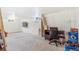 Finished basement with carpet, desk, office chair, and a wall mounted TV at 111 S Eaton St, Lakewood, CO 80226
