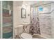 Bathroom featuring a shower, toilet and cabinet for linen storage at 111 S Eaton St, Lakewood, CO 80226