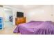 Bright bedroom featuring carpeted floors, wall-mounted TV, and dresser at 111 S Eaton St, Lakewood, CO 80226