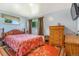 Cozy bedroom with wooden bed frame, dresser and bright natural light from the two windows at 111 S Eaton St, Lakewood, CO 80226
