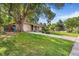 The exterior view showcases a well-kept lawn with a mature tree and a glimpse of the home's facade at 111 S Eaton St, Lakewood, CO 80226