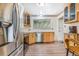 Well-lit kitchen featuring stainless steel appliances, and wooden cabinets at 111 S Eaton St, Lakewood, CO 80226