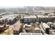 An aerial view showcases a city neighborhood featuring modern apartments, solar panels and city skyline in the background at 1749 Boulder St, Denver, CO 80211