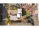 Aerial view shows a home with patio, yard with small trees, surrounded by other homes and a narrow street at 1749 Boulder St, Denver, CO 80211