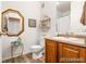 Comfortable bathroom with attractive mirror, ornate decorative shelving and wood vanity at 833 E 98 Ave # 204, Thornton, CO 80229