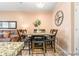 Open-concept dining area with a wooden table set for six and a view of the living area at 833 E 98 Ave # 204, Thornton, CO 80229