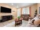 Inviting living room with a large television, plush seating, and plenty of natural light at 833 E 98 Ave # 204, Thornton, CO 80229