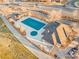Aerial view of a community pool and clubhouse near a road, perfect for summer recreation at 833 E 98 Ave # 204, Thornton, CO 80229