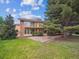 Spacious backyard featuring a stone patio and an upper level deck, perfect for outdoor entertainment and relaxation at 10506 Brown Fox Trl, Littleton, CO 80125