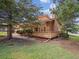 Home featuring a cozy deck area, surrounded by mature trees, providing a private and serene outdoor space at 10506 Brown Fox Trl, Littleton, CO 80125