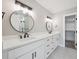Bright bathroom with double sink vanity and modern lighting fixtures at 10506 Brown Fox Trl, Littleton, CO 80125
