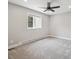Cozy bedroom features a ceiling fan, plush carpet, and a window offering natural light and outdoor views at 10506 Brown Fox Trl, Littleton, CO 80125