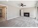 Large bedroom showcasing neutral colors, plush carpet, a ceiling fan and a cozy fireplace for a relaxed ambiance at 10506 Brown Fox Trl, Littleton, CO 80125
