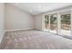 Bedroom featuring plush carpet, recessed lighting, and large window with access to the outdoor balcony at 10506 Brown Fox Trl, Littleton, CO 80125