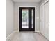 Home entryway featuring decorative glass front door, white trim, modern gray walls and closet at 10506 Brown Fox Trl, Littleton, CO 80125